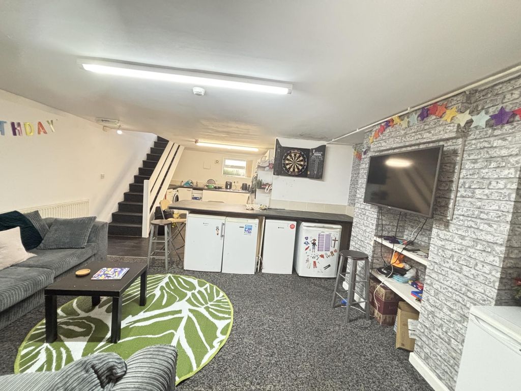 Property photo 3 of 12 A Spacious And Welcoming Living Room Featuring A c...