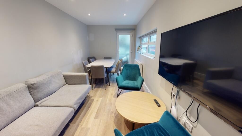 Property photo 2 of 7 This Inviting Living Room Features Modern Furnishi...