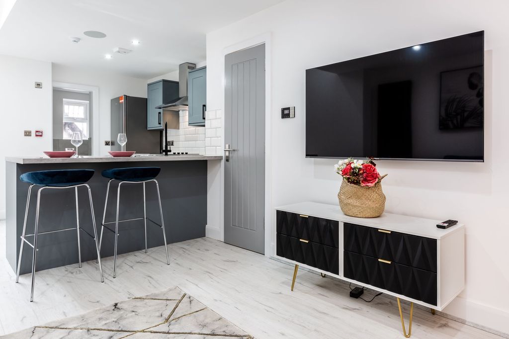 Property photo 2 of 7 Modern And Stylish Living Room Featuring A Large F...