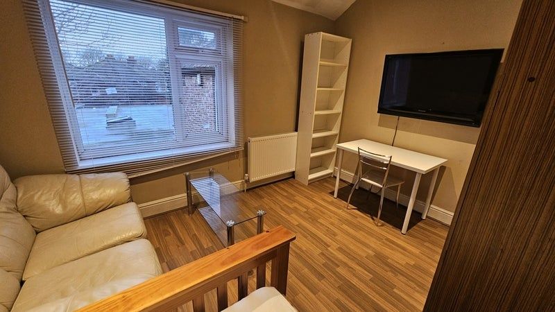 Property photo 3 of 10 A Cozy Living Room Featuring A Comfortable Cream l...
