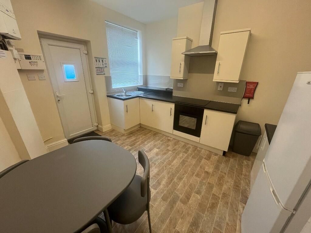 Property photo 2 of 10 Bright And Tidy Kitchen Featuring Modern Cabinetry...