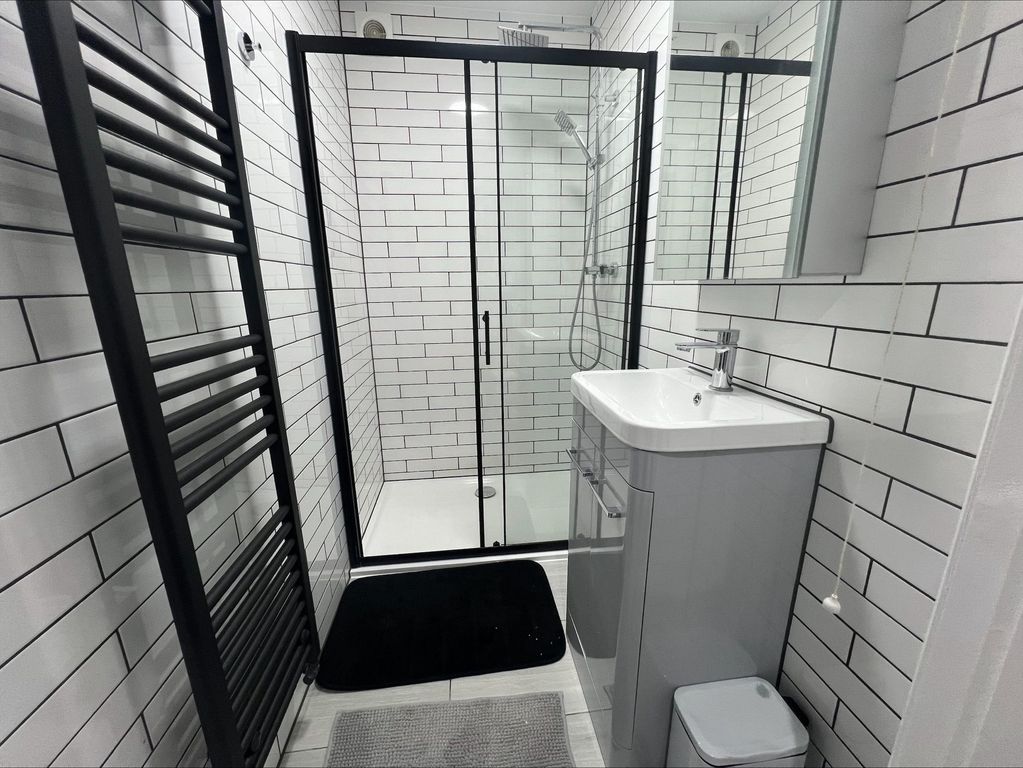Property photo 3 of 13 Modern Bathroom Featuring Sleek White Subway Tiles...