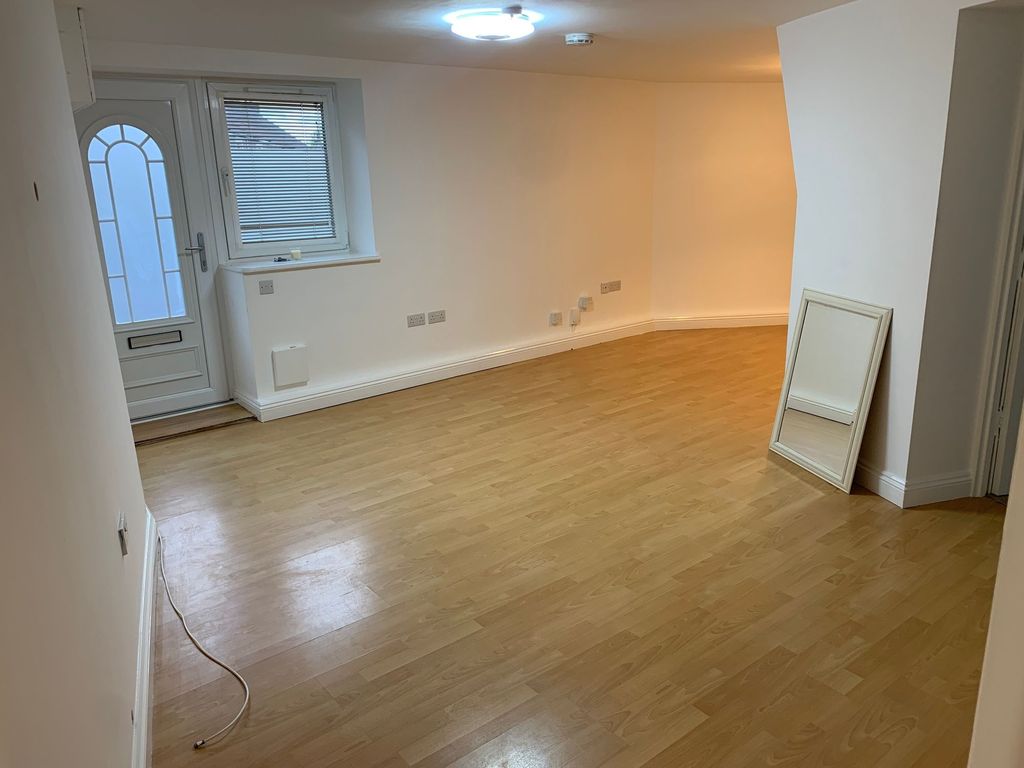 Property photo 3 of 10 A Spacious And Clean Living Room Featuring Light W...