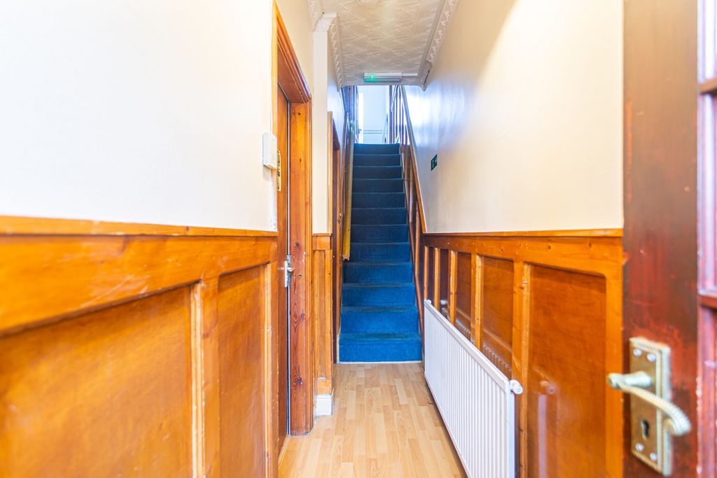 Property photo 3 of 14 Welcoming Hallway Featuring Beautiful Wood Panelin...