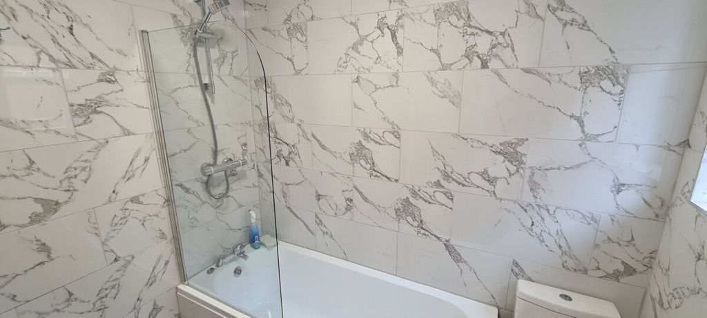 Property photo 3 of 7 Modern Bathroom With Elegant Marble-Look Wall Tile...