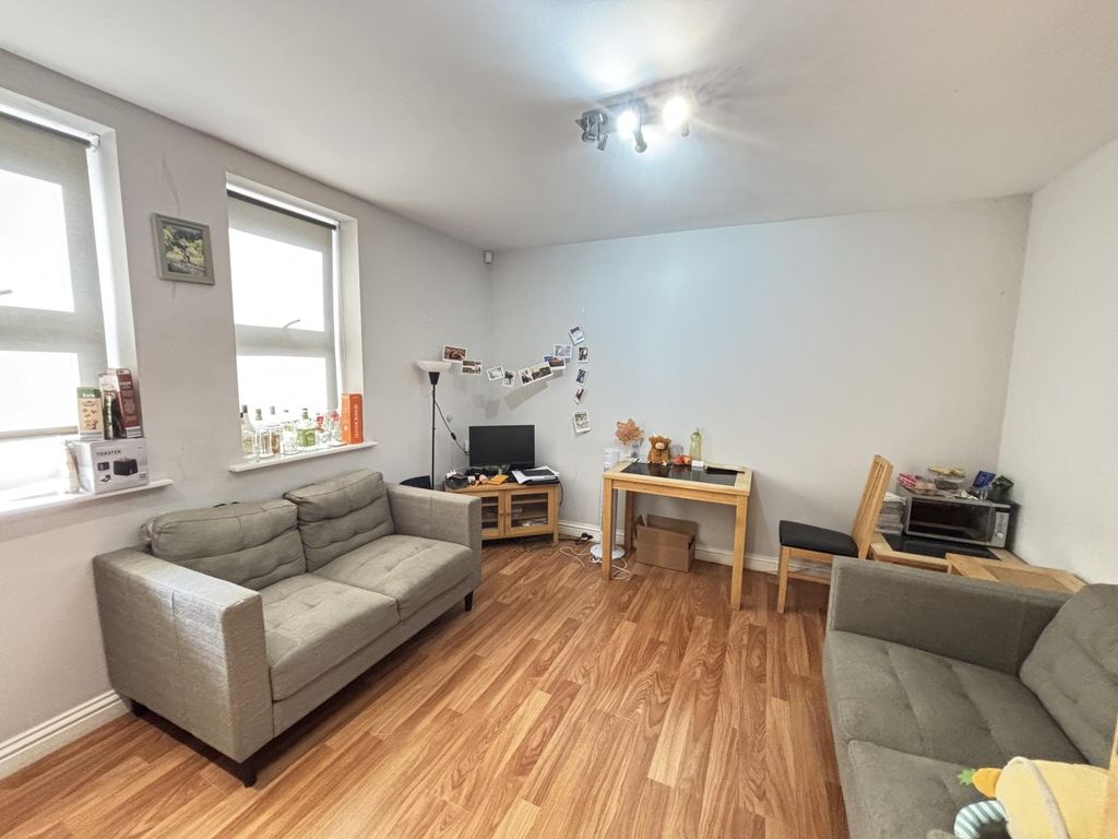 Property photo 3 of 6 A Bright And Welcoming Living Room Featuring Comfo...