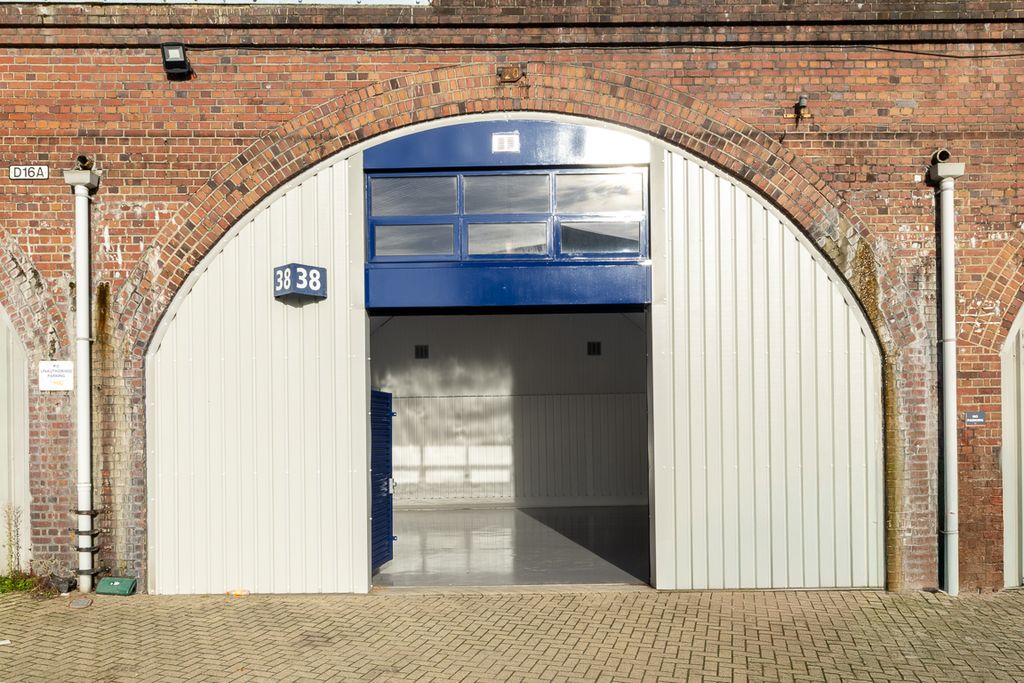 Property photo 1 of 3 The Front Of An Arch, With High Level Glazing, And An Open Electric Roller Shutter Entrance Big Enough For Vehicle Access.