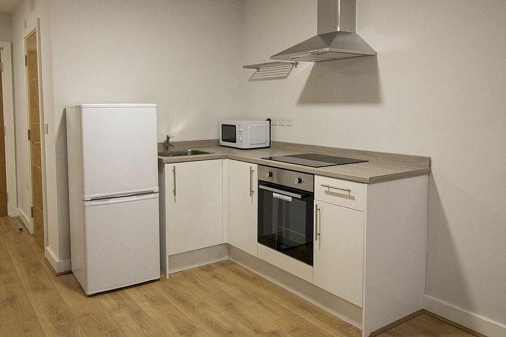 Property photo 2 of 5 Modern Kitchen Featuring Sleek Cabinetry And Appli...