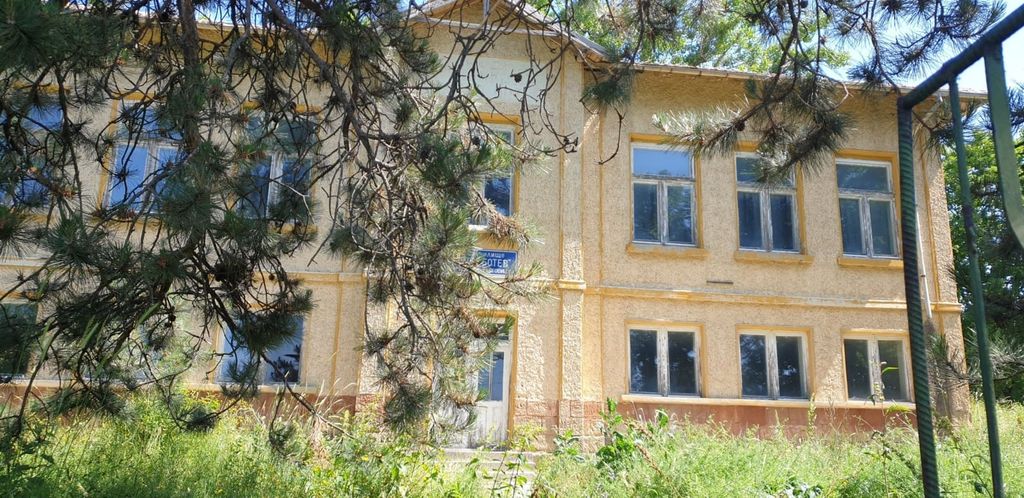 Property photo 3 of 94 View Of The Former School Building With Yellow Walls And Many Windows, Partially Hidden By Pine Tree Branches