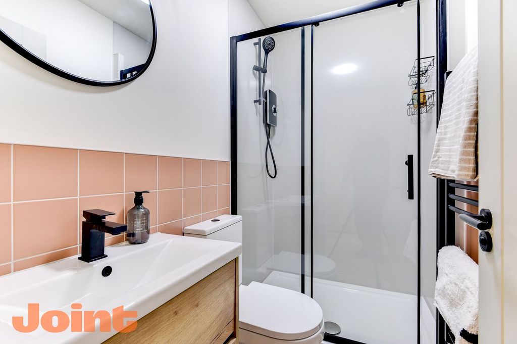 Property photo 1 of 12 Modern Bathroom With Chic Pink Tiles And Shower...