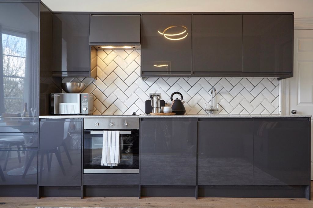 Property photo 2 of 6 A Modern And Clean Kitchen Featuring Sleek Grey Ca...