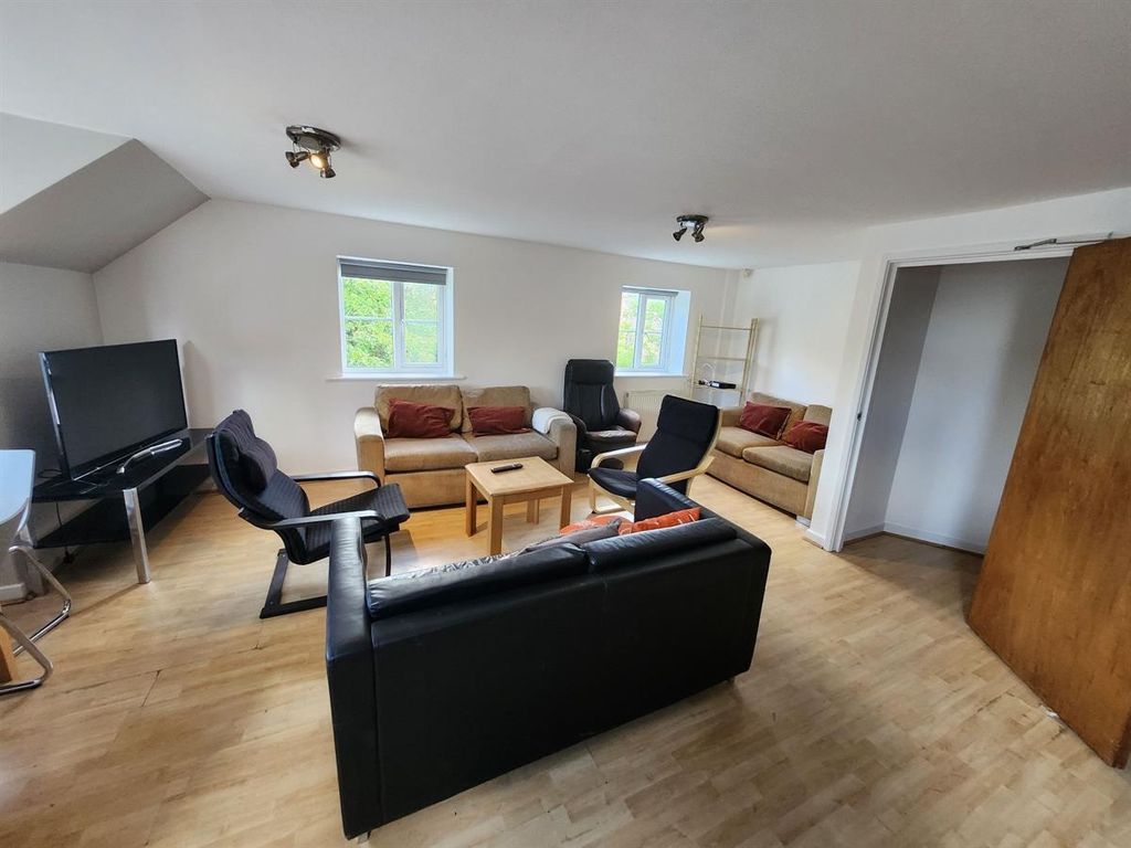 Property photo 2 of 13 A Spacious And Inviting Living Room Featuring A mi...