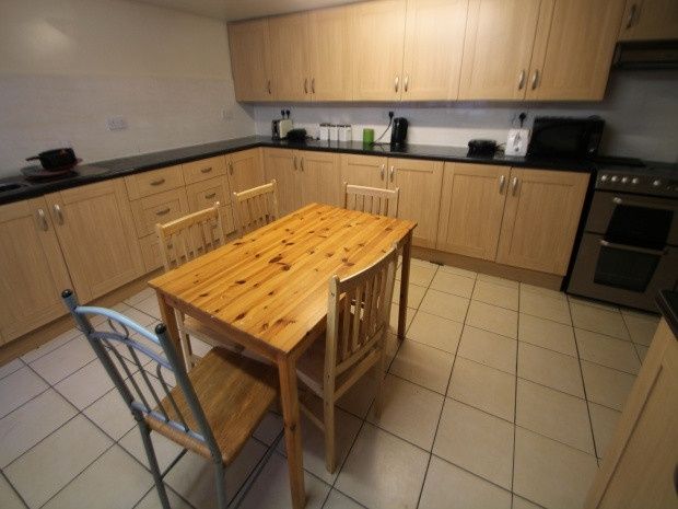 Property photo 3 of 7 Modern Galley-Style Kitchen With Light Wood Cabine...