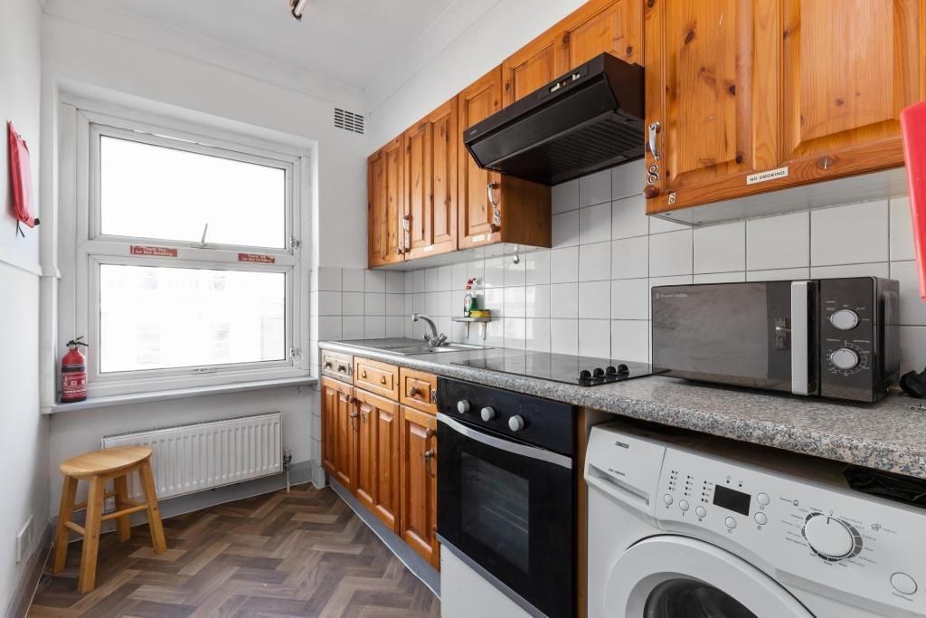 Property photo 2 of 3 Bright Kitchen With Ample Storage And Appliances...