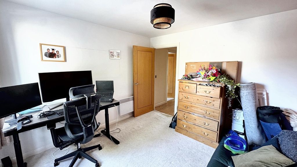 Property photo 2 of 11 A Spacious, Well-Lit Living Room Featuring A Desk ...