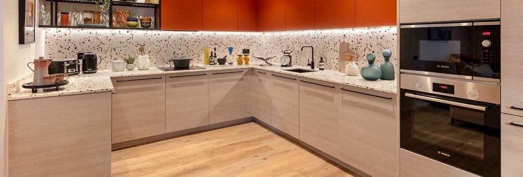 Property photo 2 of 5 Kitchen With Beige Panels And Orange Cupboards, Modern Appliances, Spotted Ceramic Splashback Tiles.