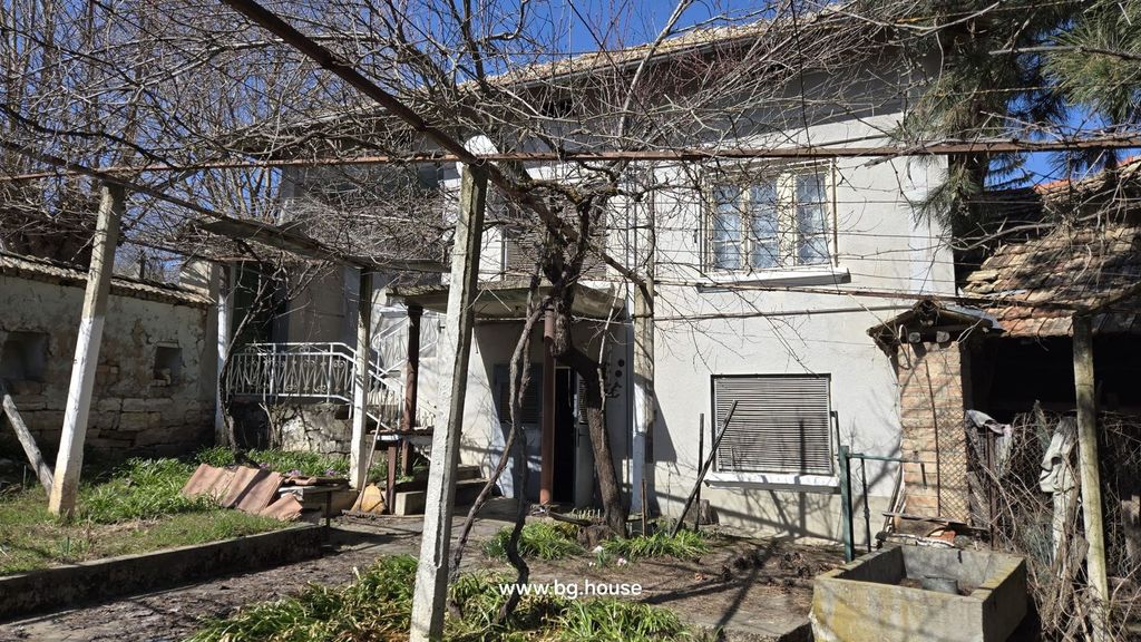 Property photo 2 of 91 Front Facade Of The House With Garden And Vine-Covered Trellis In Early Spring