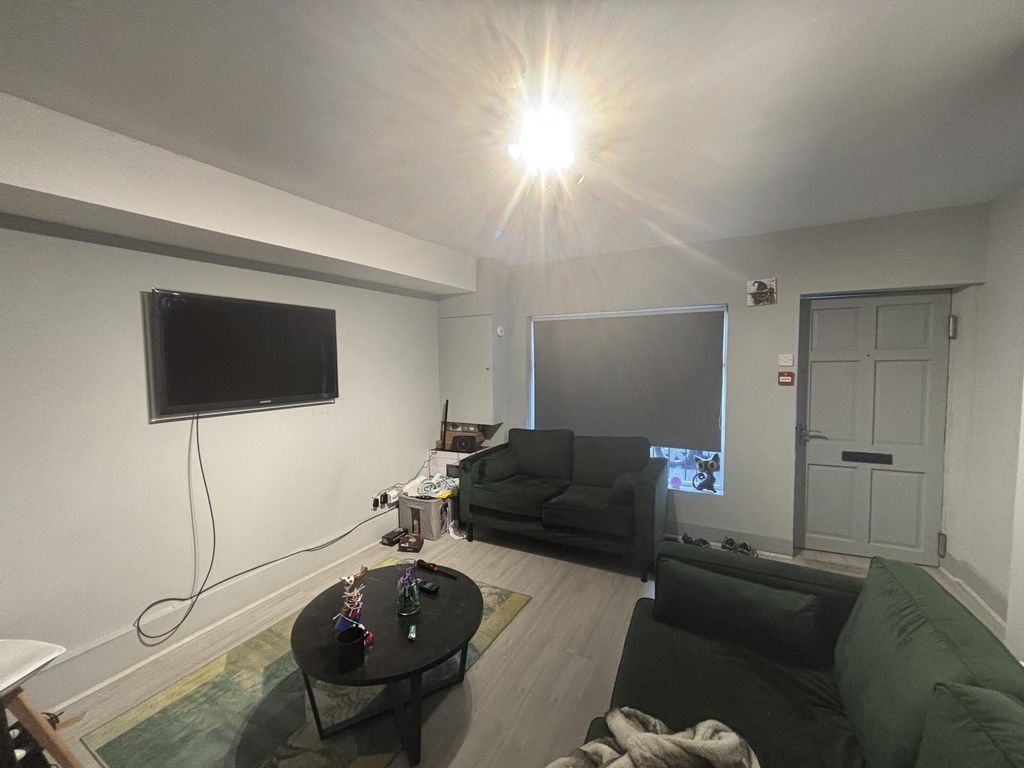 Property photo 2 of 11 A Modern, Well-Lit Living Room With Comfortable Se...