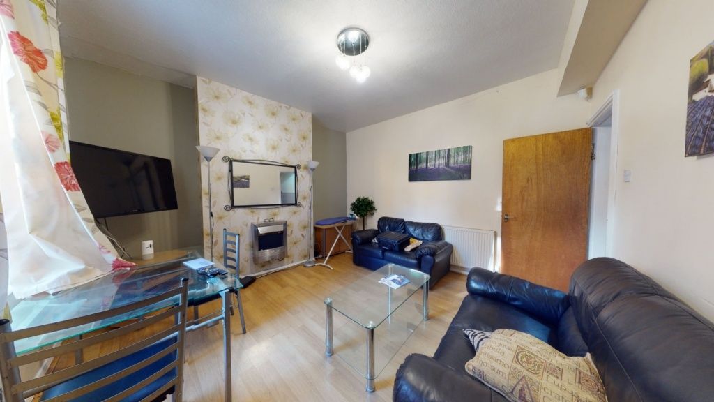 Property photo 1 of 8 Bright And Inviting Living Room Featuring Comforta...
