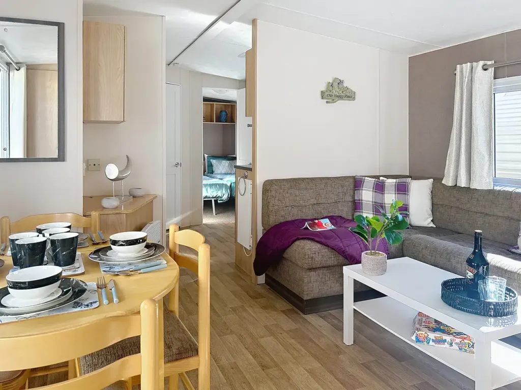 Property photo 1 of 17 Open Plan Living Area With L-Shaped Sofa And Dining Table With Chairs In The Delta Feria Holiday Caravan At Pakefield Holiday Park, Suffolk