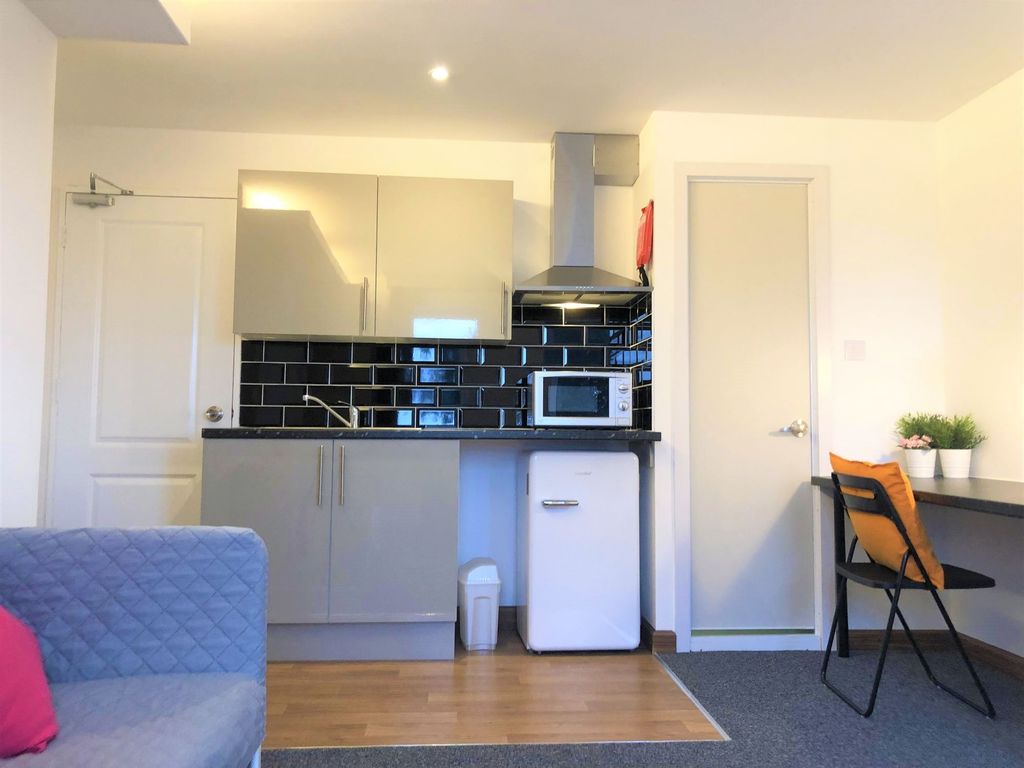 Property photo 3 of 6 Bright And Modern Kitchen Area Featuring Sleek Gre...