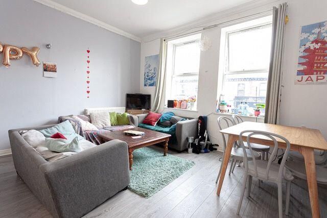 Property photo 3 of 15 A Bright And Cozy Living Room Featuring A Comforta...