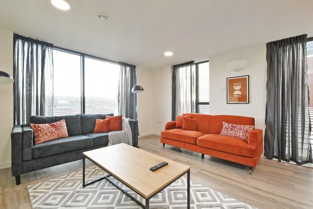 Property photo 3 of 14 Bright And Stylish Living Room Featuring Large Win...