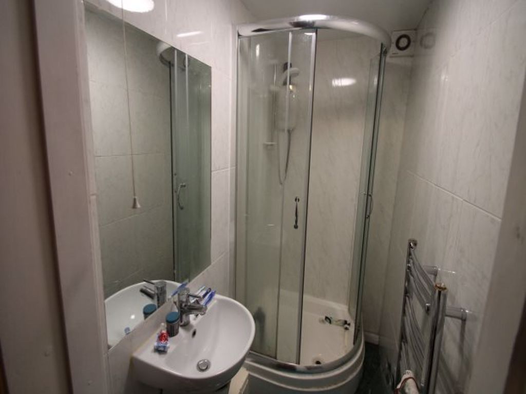 Property photo 2 of 9 A Clean, Modern Bathroom Featuring A Corner Shower...