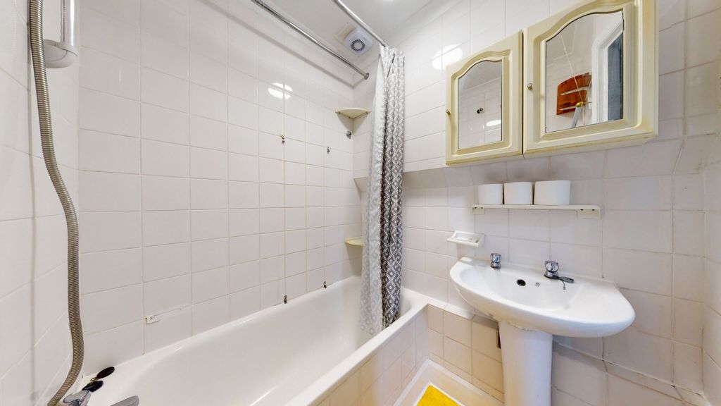 Property photo 1 of 7 Bright And Clean Bathroom Featuring A Classic Whit...
