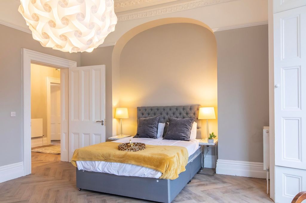 Property photo 3 of 12 Bright, Elegant Bedroom With A Tufted Grey Headboa...