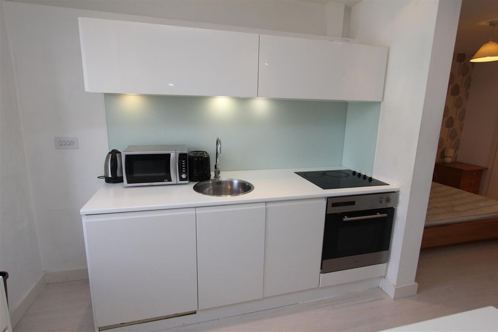 Property photo 2 of 7 Modern Compact Kitchen With Sleek White Units...
