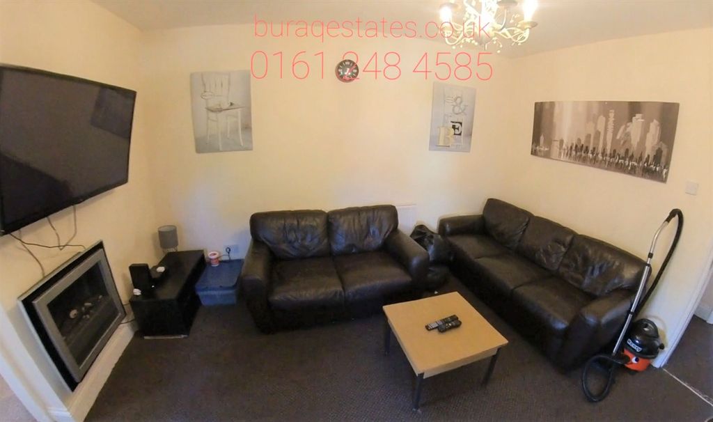 Property photo 1 of 10 A Spacious And Inviting Living Room Featuring Mode...