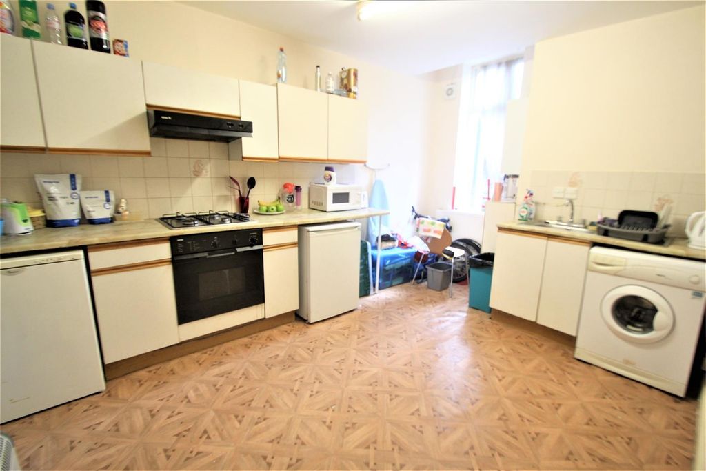 Property photo 3 of 6 A Spacious Kitchen Featuring White Cabinets, A Gas...