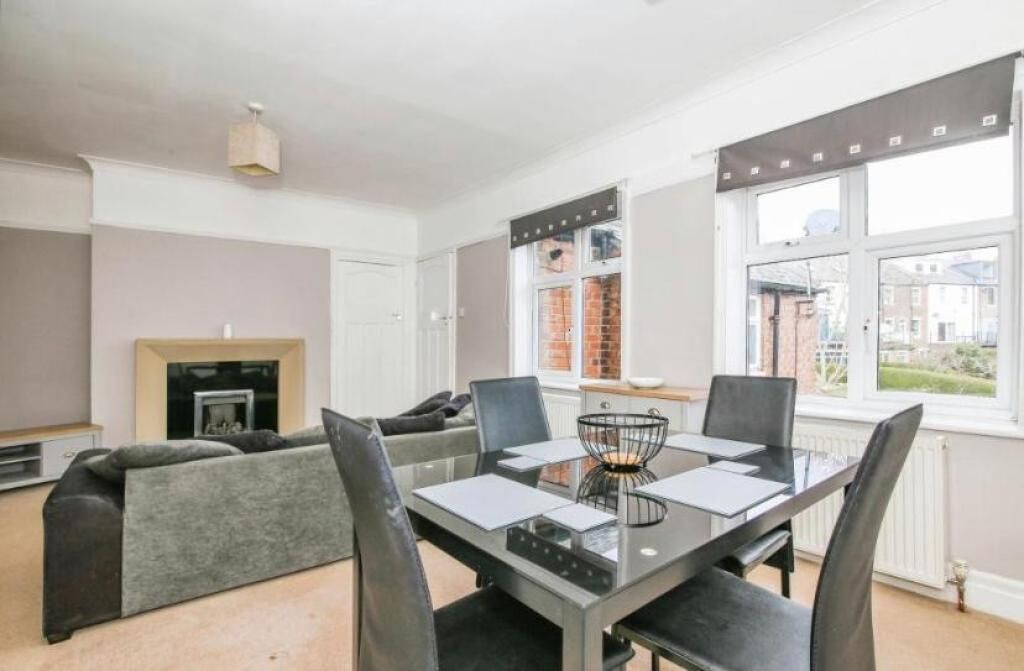 Property photo 3 of 10 This Spacious Living Room Offers A Warm And Inviti...