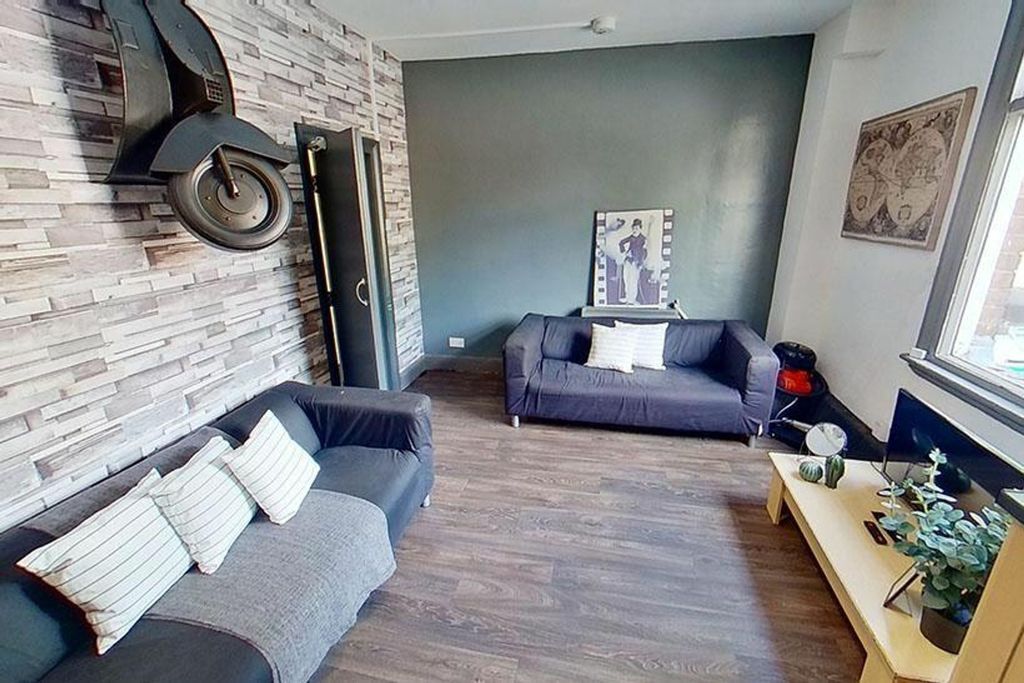 Property photo 2 of 9 A Stylish Living Room Featuring Comfortable Seatin...