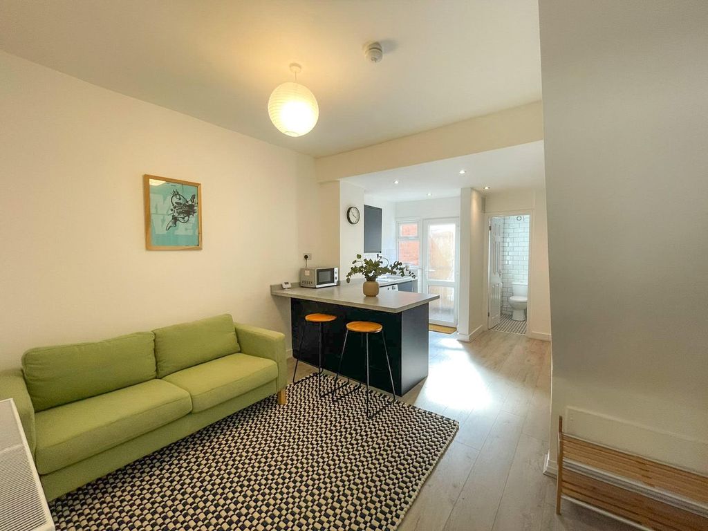 Property photo 2 of 12 A Spacious And Modern Living Room Featuring A Cozy...