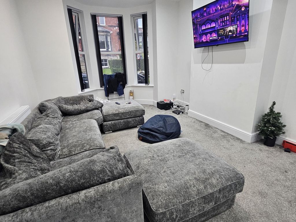 Property photo 2 of 22 A Modern And Spacious Living Room Featuring A Larg...