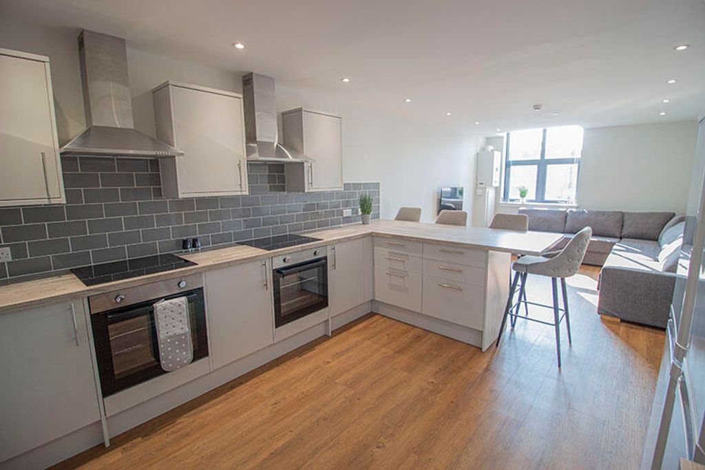Property photo 3 of 10 Modern Kitchen Featuring Sleek Cabinetry, Ample Co...