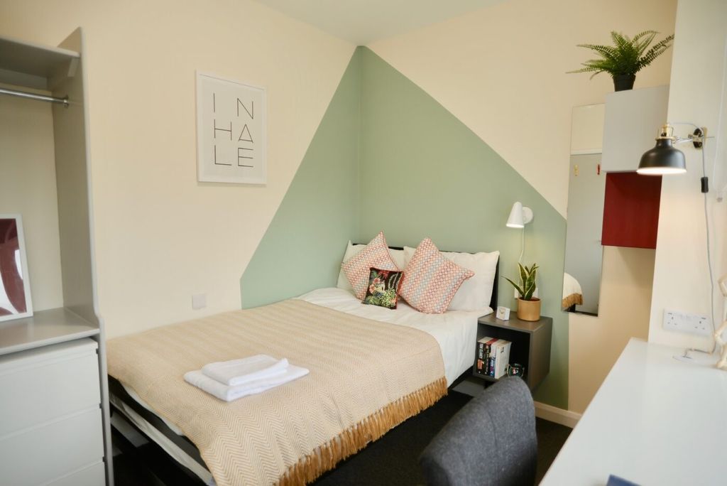 Property photo 3 of 6 A Bright And Stylish Bedroom Featuring A Cozy Doub...