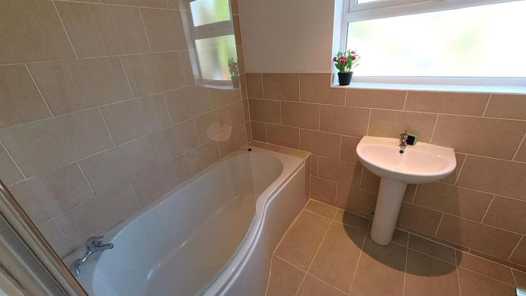 Property photo 1 of 8 Bright Bathroom With Modern Tub And Sleek Tiling...