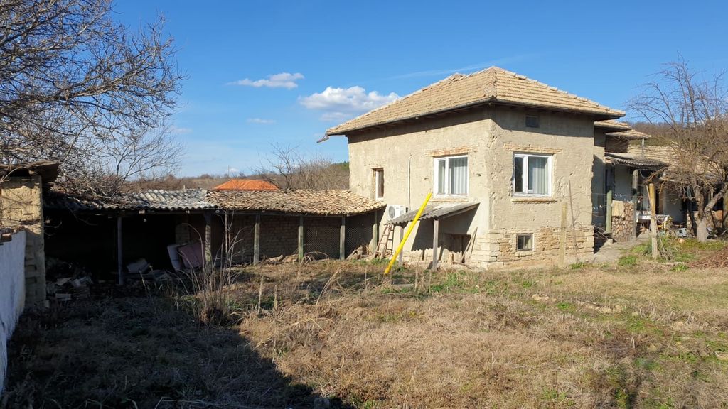 Property photo 1 of 100 Exterior View Of A Traditional Bulgarian House With A Tiled Roof And Adjacent Outbuildings In A Rural Yard