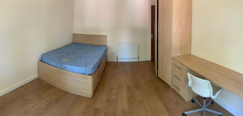 Property photo 2 of 10 A Tidy And Well-Lit Bedroom Featuring A Comfortabl...