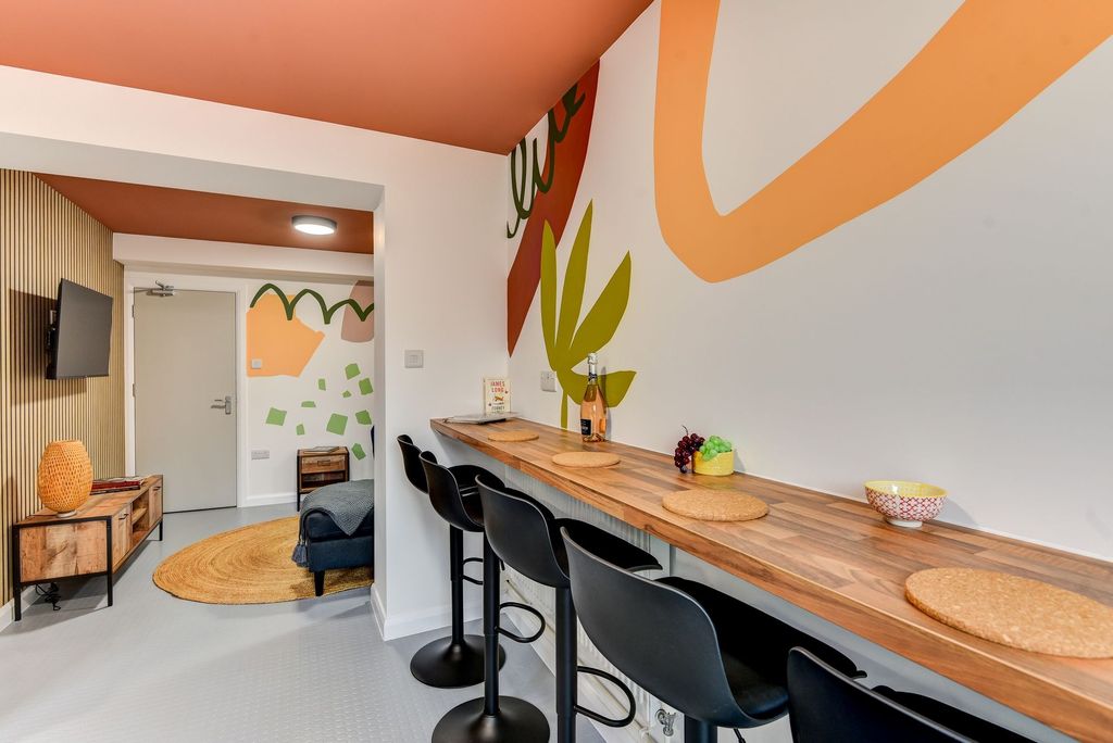 Property photo 3 of 6 A Stylish Communal Lounge Featuring A Long Wooden ...