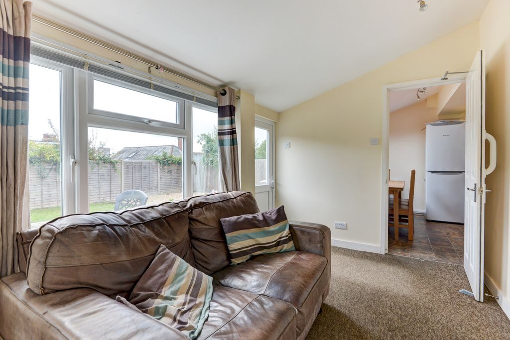 Property photo 2 of 23 A Welcoming Living Room Featuring A Large, Comfort...