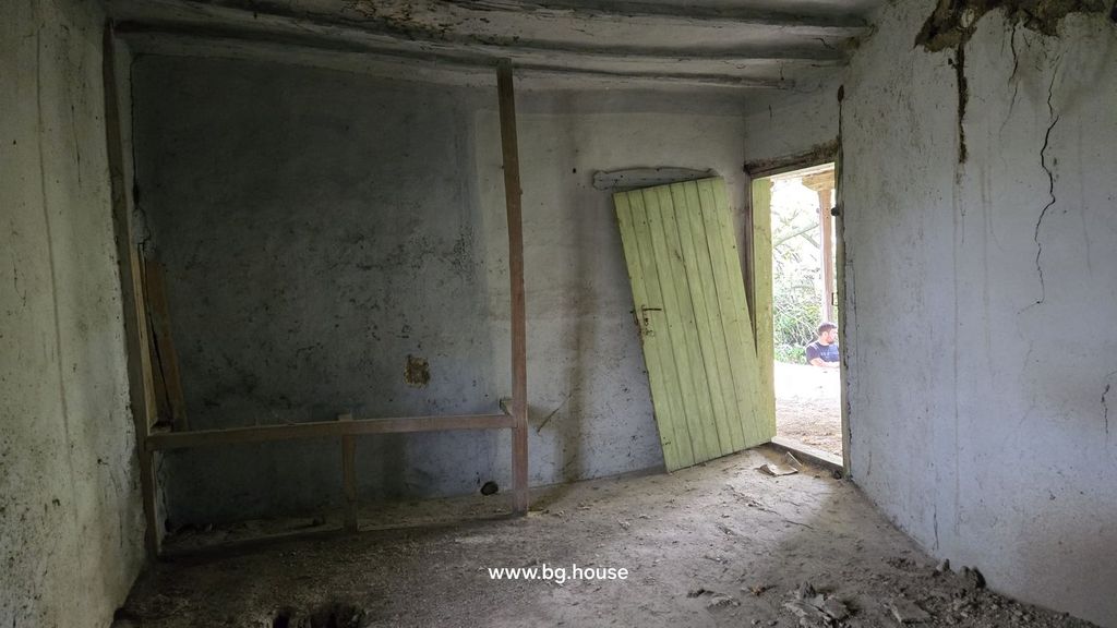 Property photo 2 of 47 Interior Room With Bare Walls And A Wooden Door Leaning Open To The Outside.