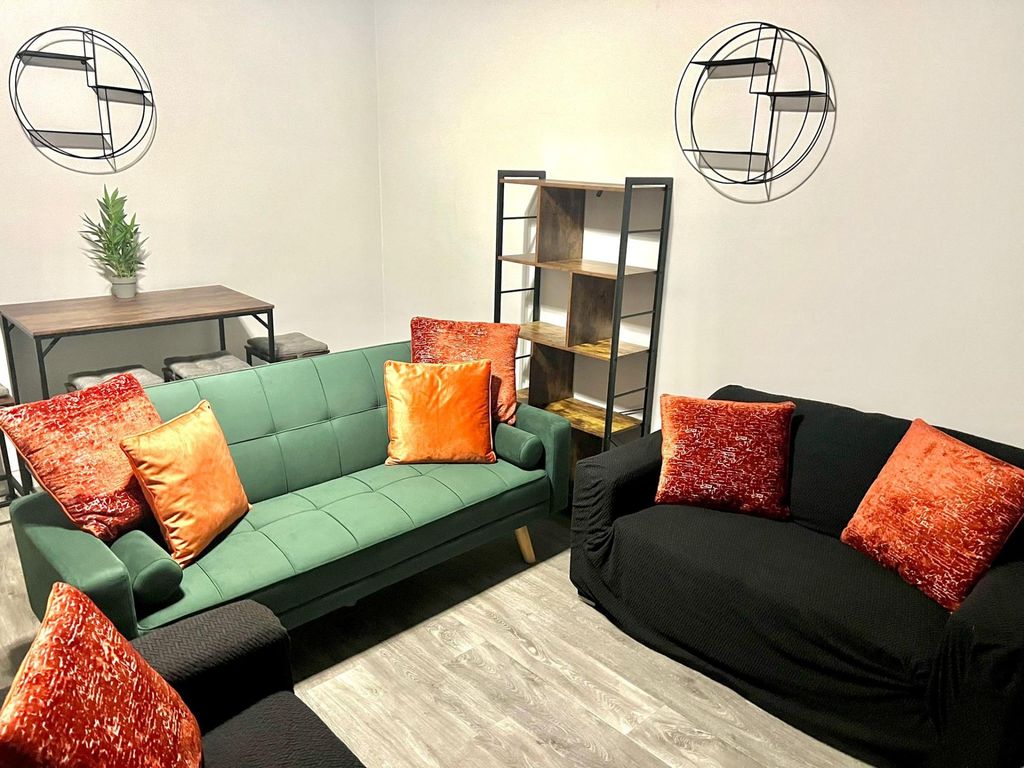 Property photo 1 of 16 A Stylish And Inviting Living Room Featuring A Mod...