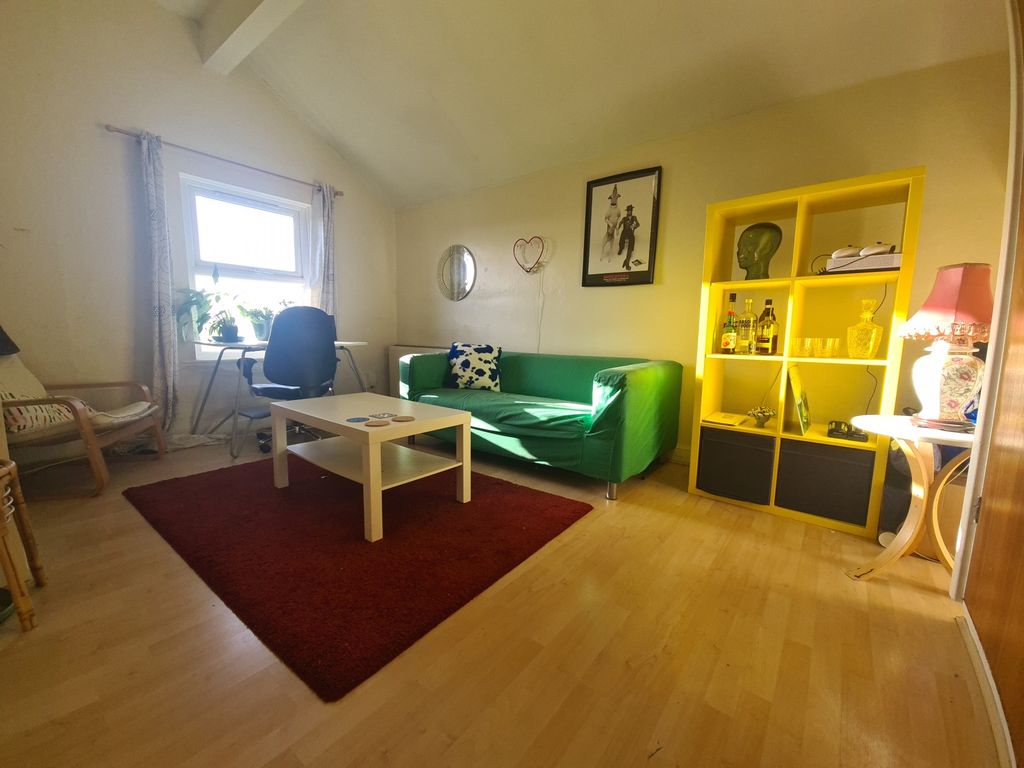 Property photo 1 of 5 A Bright And Welcoming Living Room Featuring A Vib...
