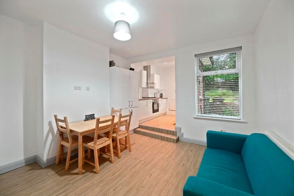 Property photo 3 of 15 A Bright And Airy Living Room Featuring A Teal Sof...