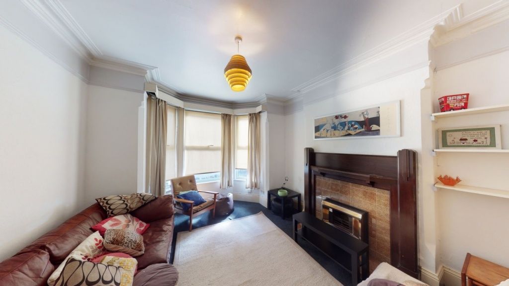 Property photo 3 of 8 A Charming Living Room Featuring A Cozy Fireplace,...