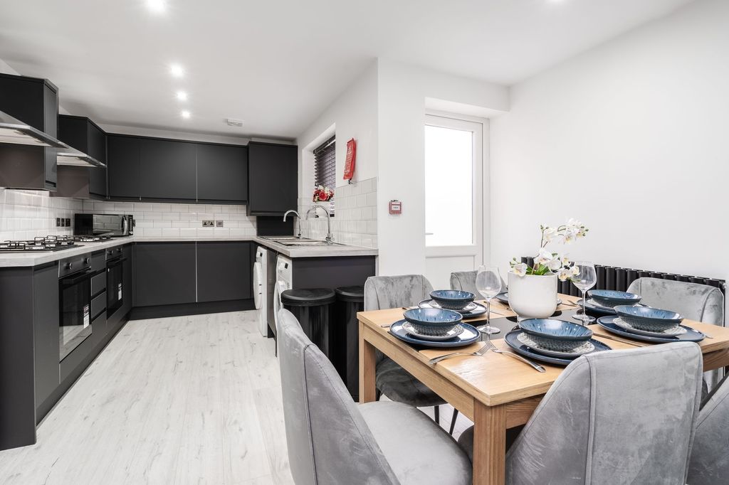 Property photo 2 of 5 Modern Kitchen With Sleek Black Cabinets, Ample Wo...